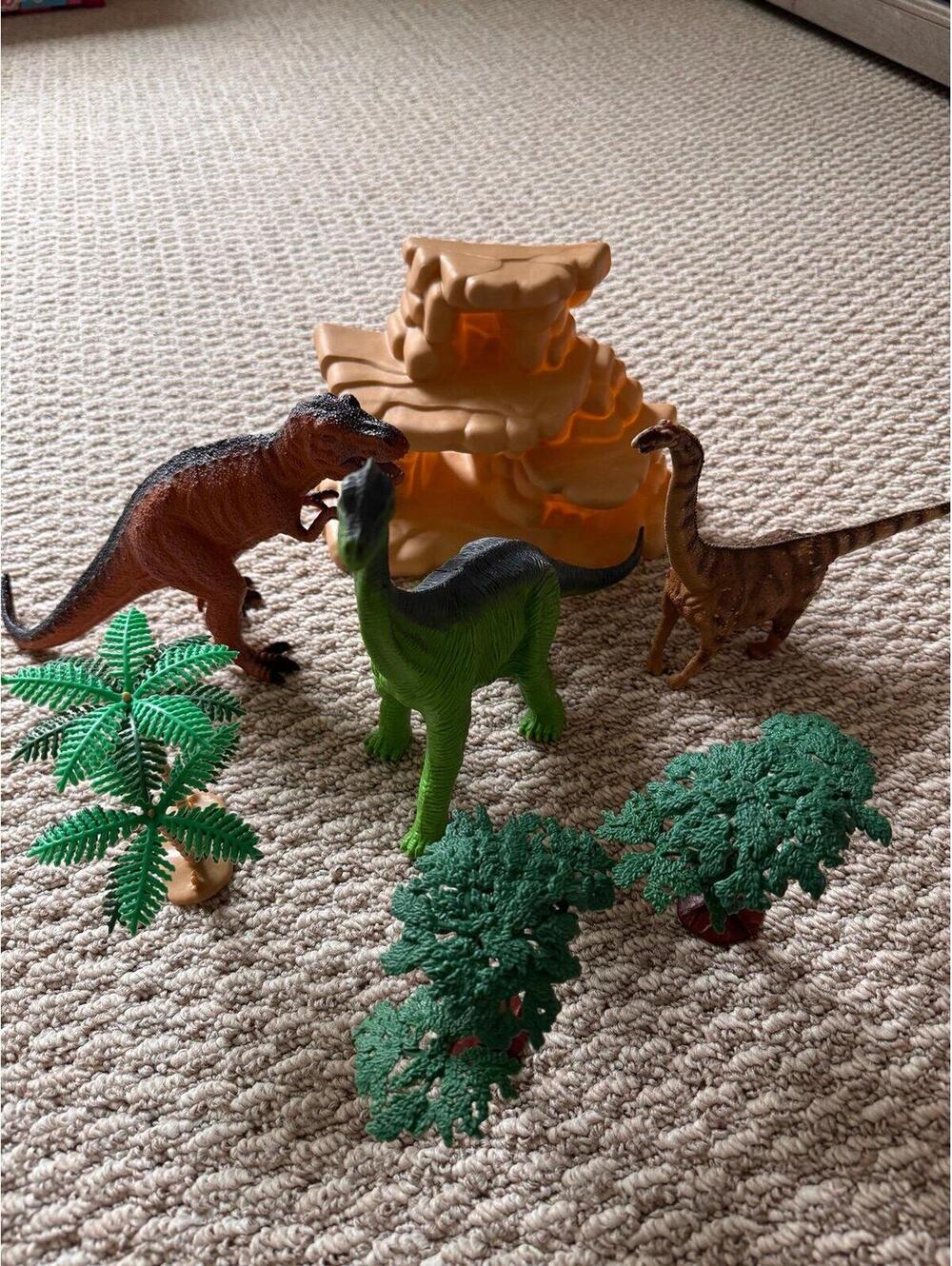 dinosaur figures tress and rock